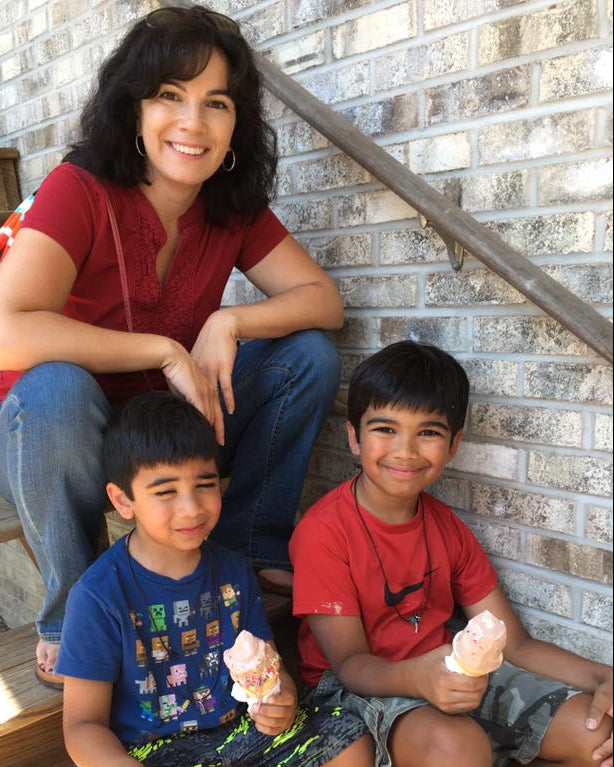 Picture of the founder, Connie with her two sons when they were young, enjoying icecream after a day at Nature Camp.